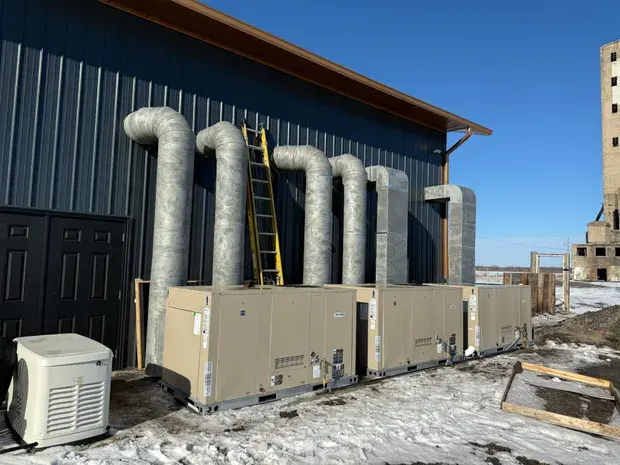 Commercial rooftop units and spiral vent risers on a Northwest Indiana building